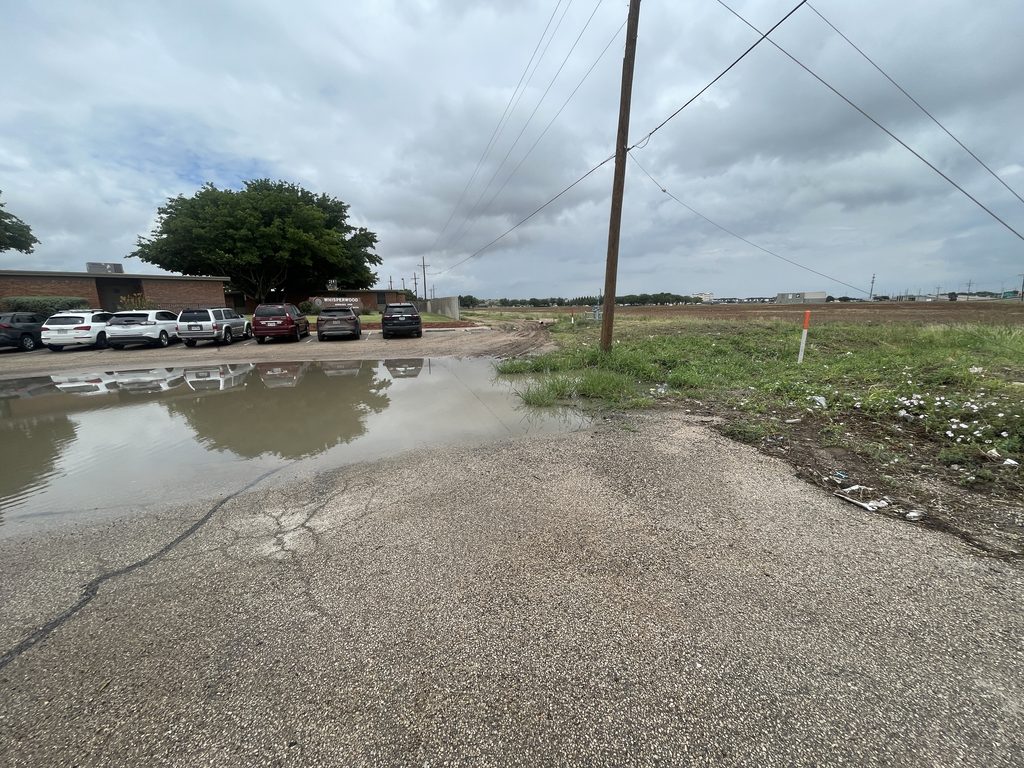 pre-construction ponding in neighbor's parking lot